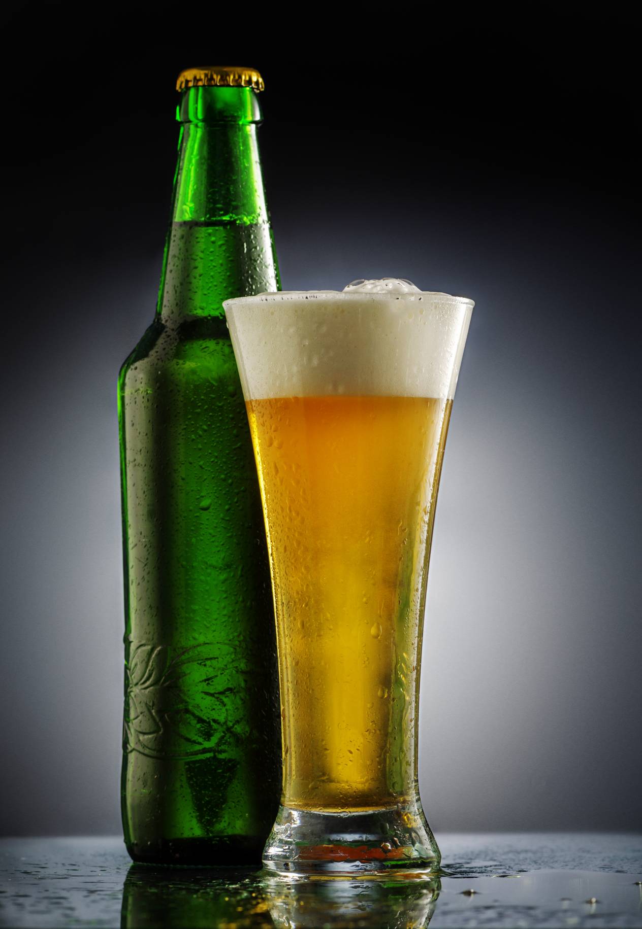 A bottle of beer and a glass of beer.