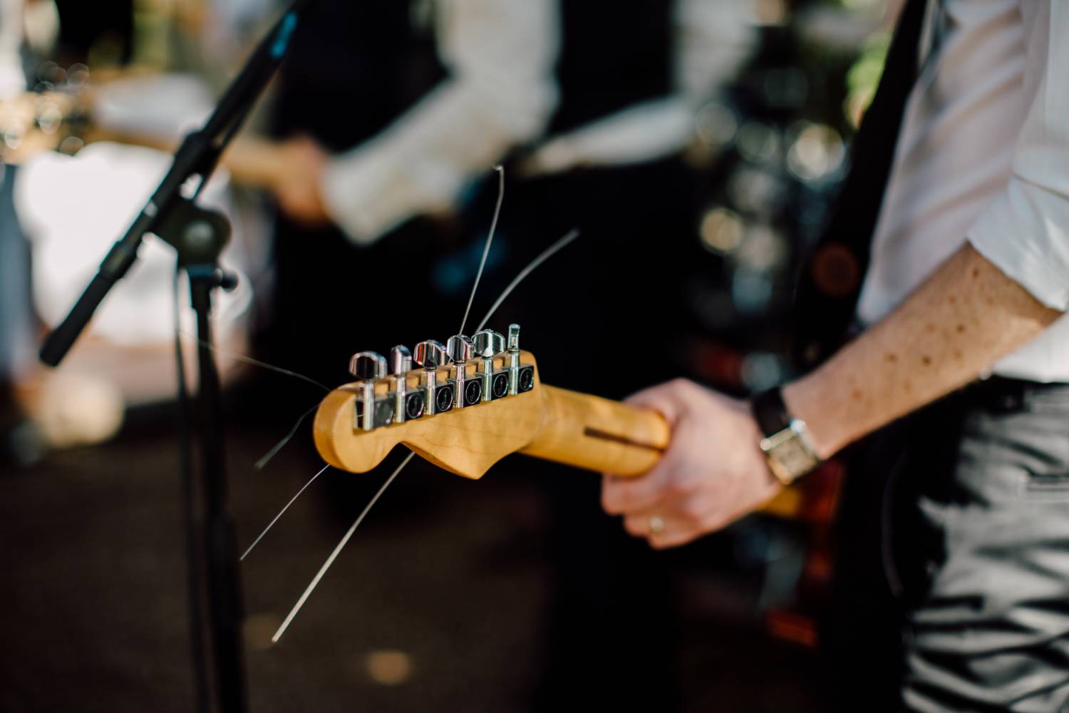 A man playing an electric guitar at a wedding.